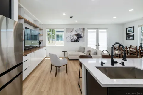 a kitchen with granite countertop a sink and a refrigerator