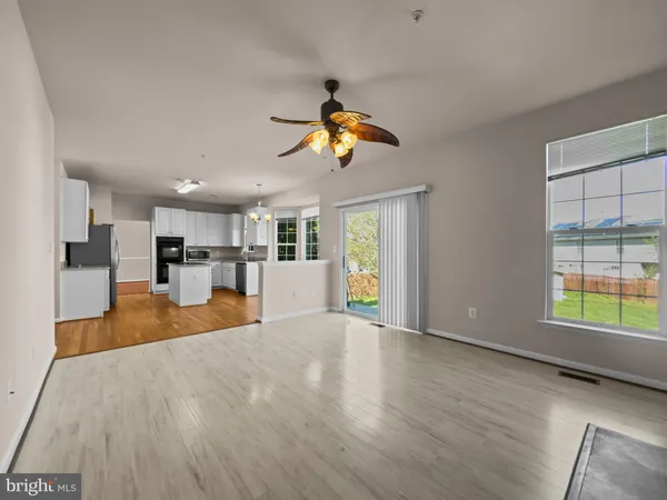 a view of a kitchen with kitchen appliances wooden floor and a window