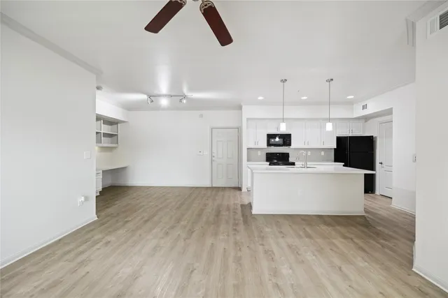 a view of kitchen with microwave and refrigerator