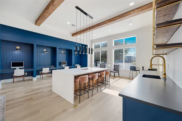 a living room with large window and furniture