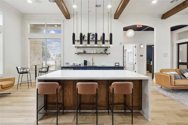a kitchen with a sink and chairs