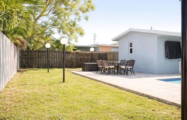 a swimming pool with outdoor seating and yard