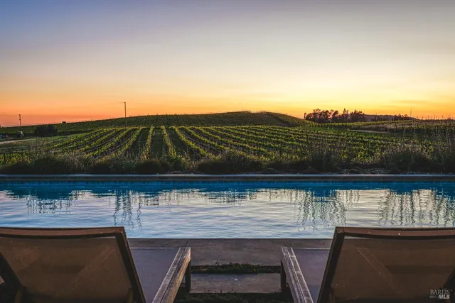 a backyard of a house with table and chairs