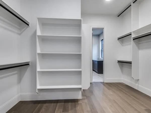 a view of walk in closet with empty racks