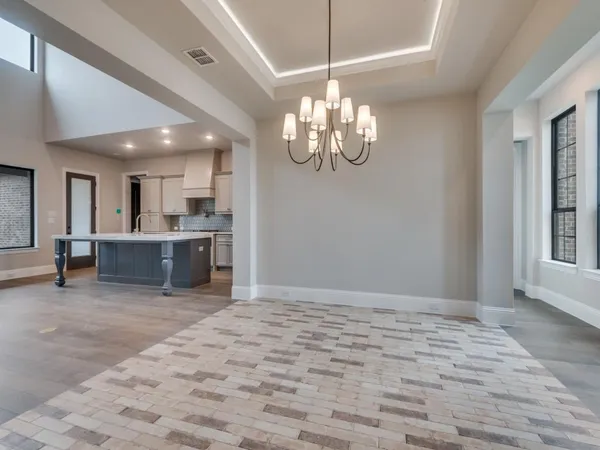 a view of a kitchen with a sink and chandelier