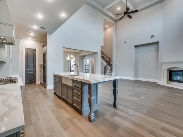 a view of living room kitchen with stainless steel appliances cabinets