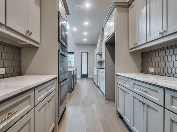 a kitchen with cabinets and a wooden floor