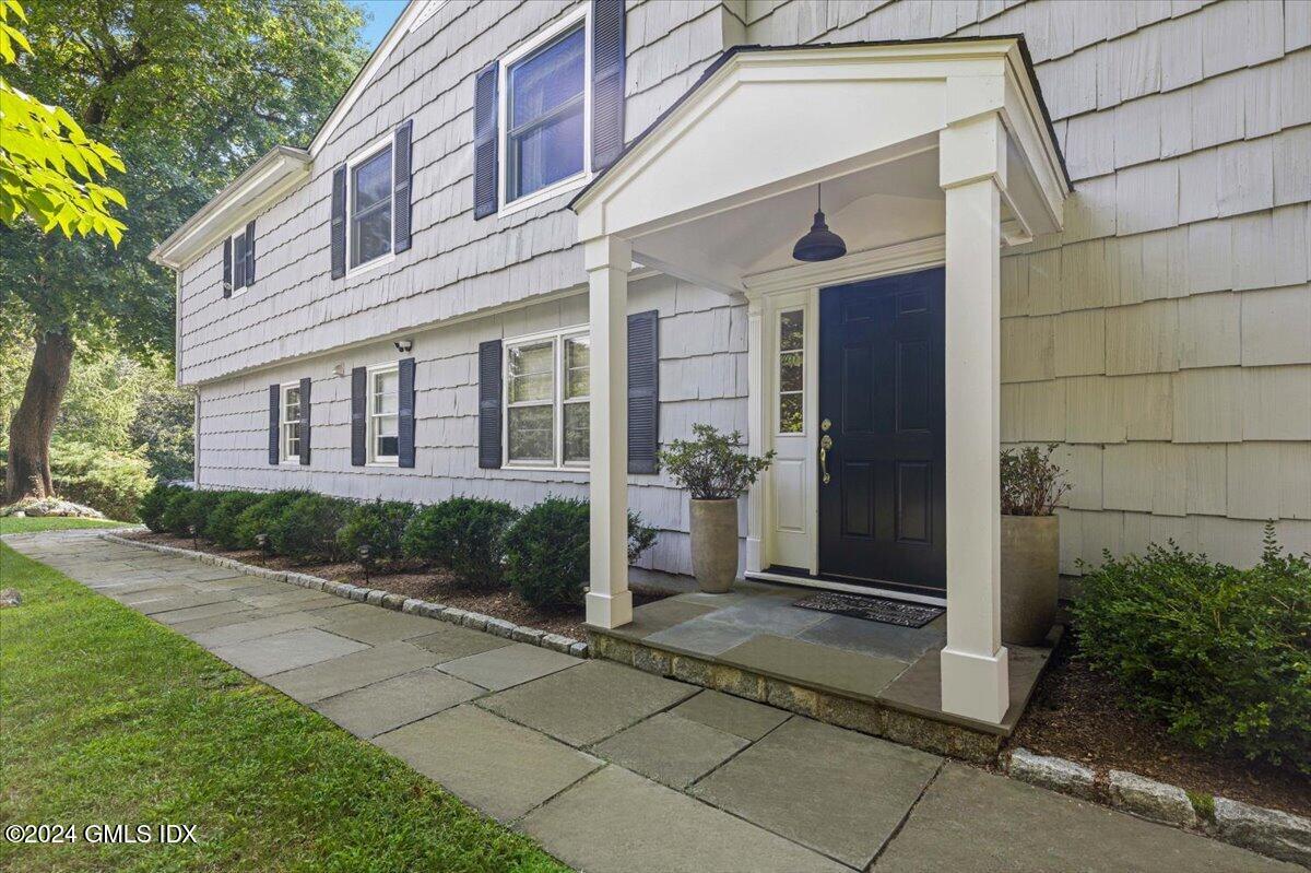 70 Gregory Road Cos Cob, CT 06807 - Photo 1 of 39 a front view of a house with a garden