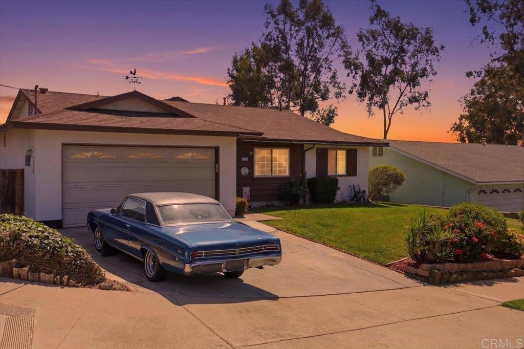 a small house with tall trees in the background