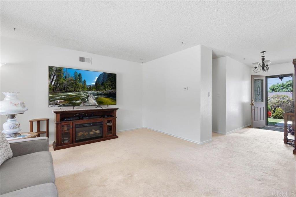 8773 Leigh Avenue Spring Valley, CA 91977 - Photo 12 of 30 a living room with furniture and a flat screen tv