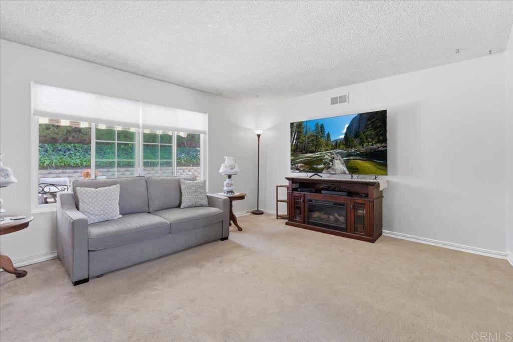 8773 Leigh Avenue Spring Valley, CA 91977 - Photo 13 of 30 a living room with furniture and a flat screen tv