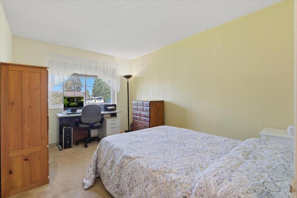 8773 Leigh Avenue Spring Valley, CA 91977 - Photo 15 of 30 a bedroom with a bed and a table in it