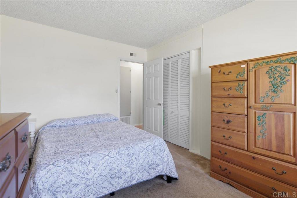 8773 Leigh Avenue Spring Valley, CA 91977 - Photo 16 of 30 a bedroom with a bed and a dresser