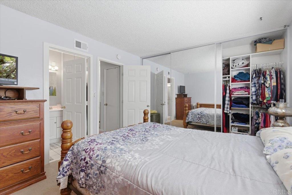 8773 Leigh Avenue Spring Valley, CA 91977 - Photo 19 of 30 a bedroom with a bed and a flat tv screen on dresser