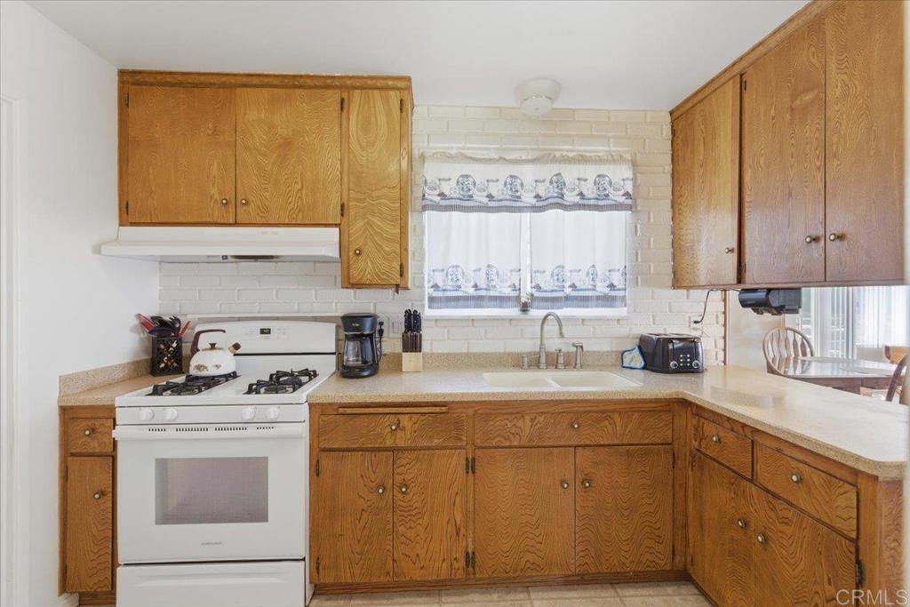 8773 Leigh Avenue Spring Valley, CA 91977 - Photo 5 of 30 a kitchen with a sink stove top oven and cabinets