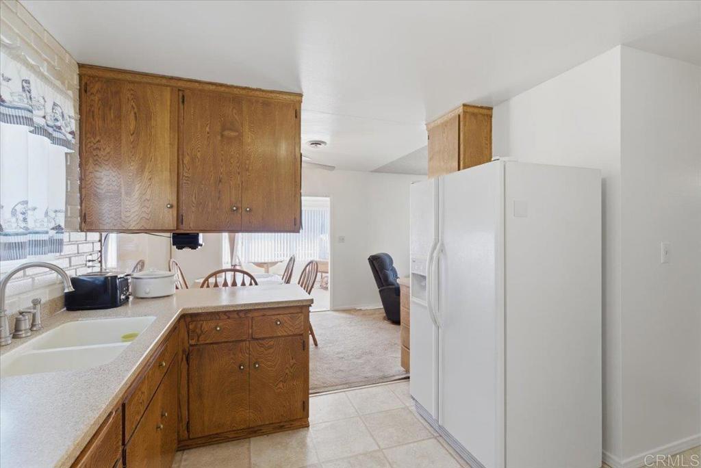 8773 Leigh Avenue Spring Valley, CA 91977 - Photo 7 of 30 a kitchen with a refrigerator and a sink