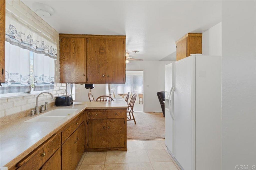 8773 Leigh Avenue Spring Valley, CA 91977 - Photo 8 of 30 a kitchen with granite countertop a sink a stove and a refrigerator