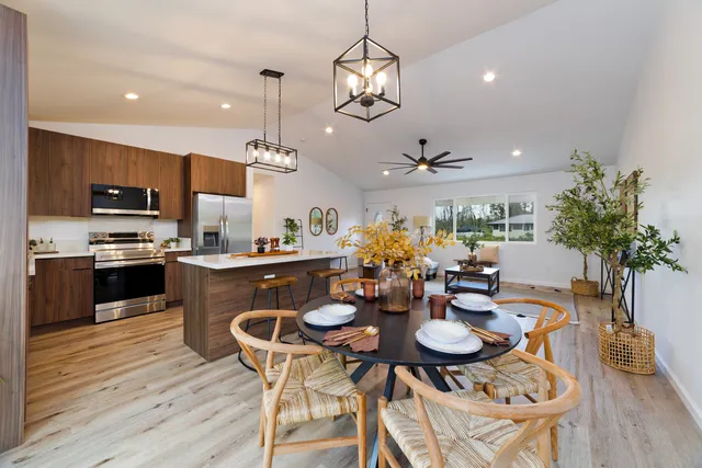 a view of a dining room with furniture kitchen and chandelier