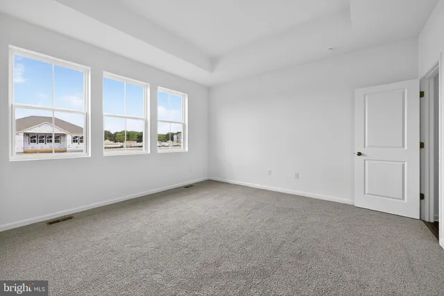 a spacious bathroom with a shower a sink and a mirror