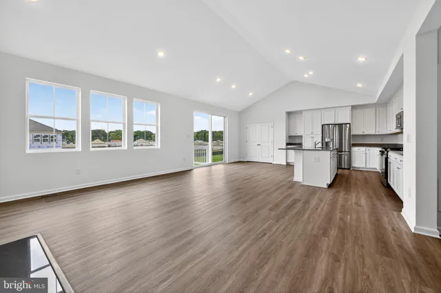 a view of large kitchen with wooden floor and a large window