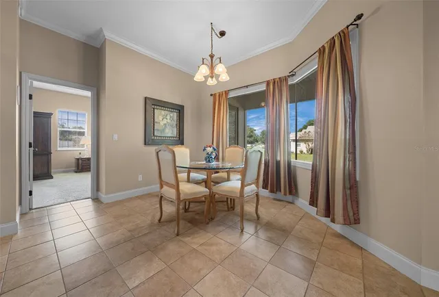a view of a dining room with furniture and chandelier