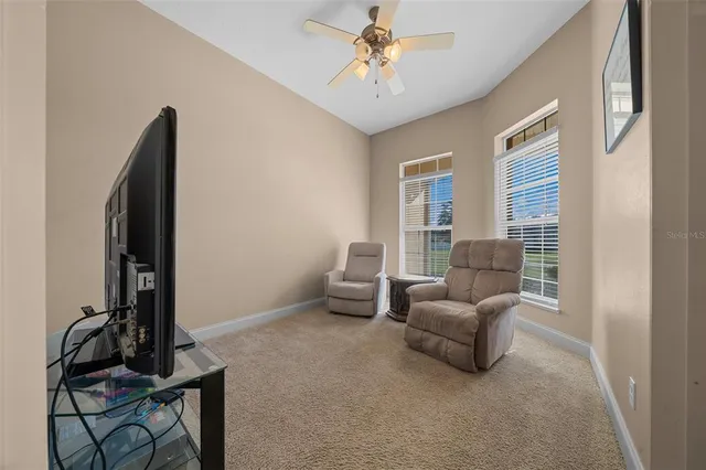 a living room with furniture a fireplace and a large window