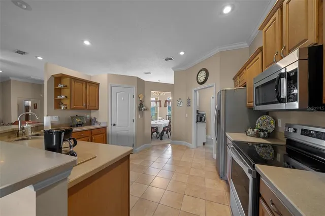 a kitchen with a sink cabinets and window