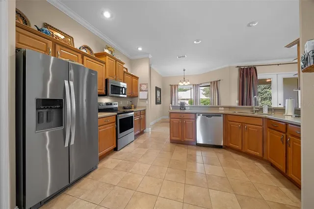 a kitchen with stainless steel appliances granite countertop a stove a refrigerator and a stove