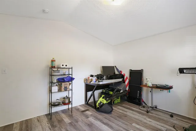 a view of a workspace with furniture and wooden floor