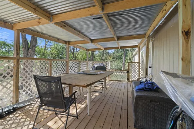 a view of a patio with table and chairs and wooden floor