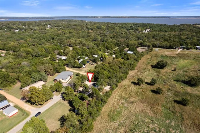 an aerial view of residential house with swimming pool and lawn chairs