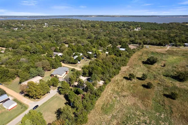 an aerial view of residential house with swimming pool and lawn chairs
