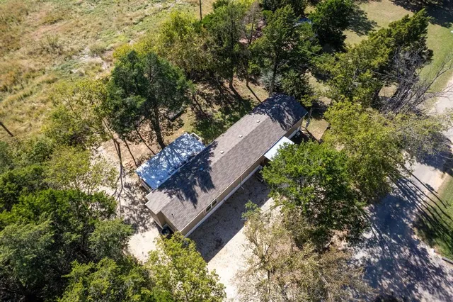 an aerial view of a house with a yard