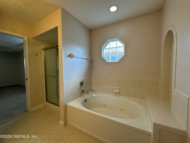 a bathroom with a bathtub and a shower