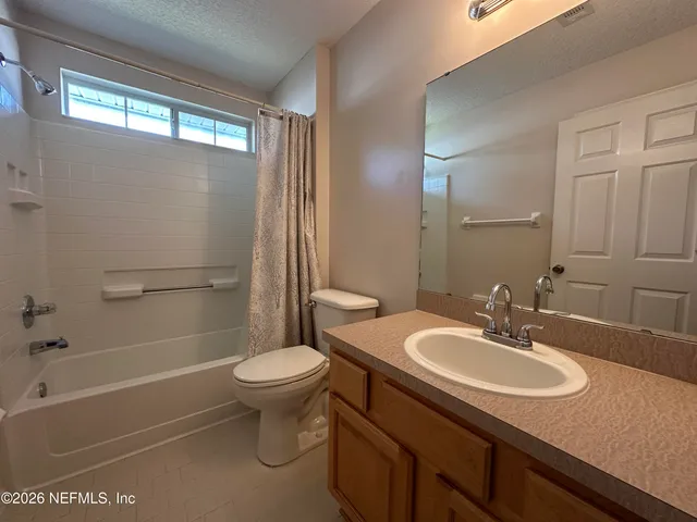 a bathroom with a sink toilet tub and shower