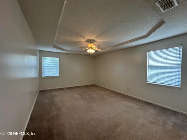 a view of a livingroom with a ceiling fan and window