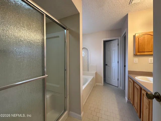 a bathroom with a bathtub and a shower