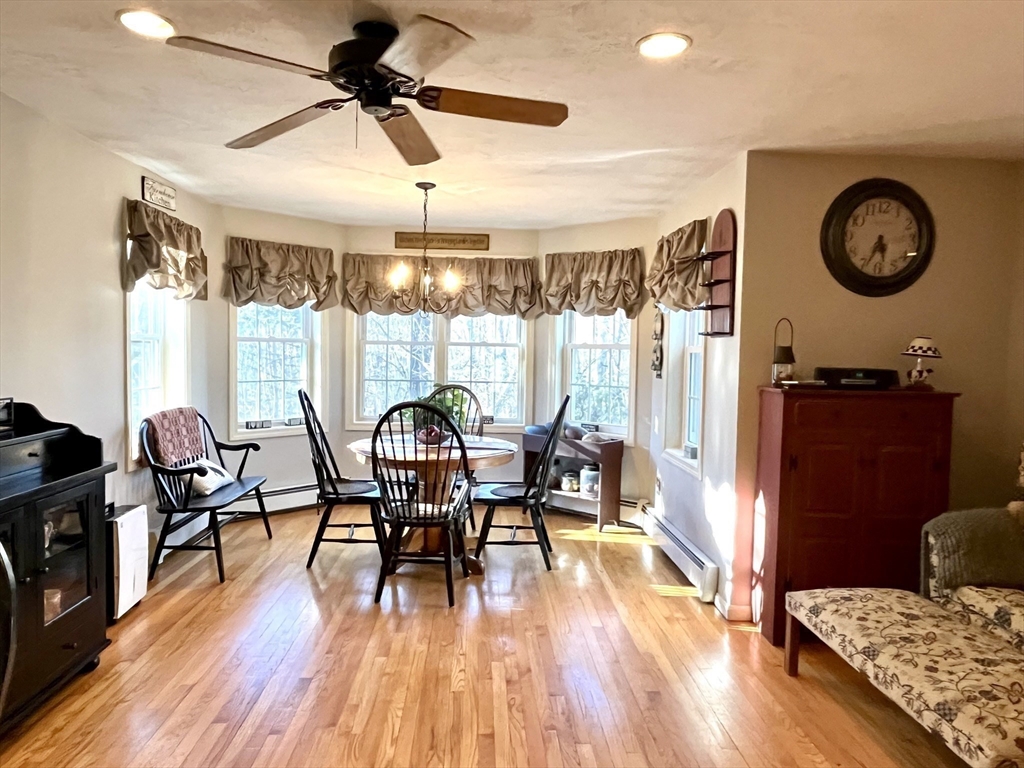 2 Pierce Circle Paxton, MA 01612 - Photo 7 of 31 a dining room with wooden floor a chandelier a wooden table and chairs