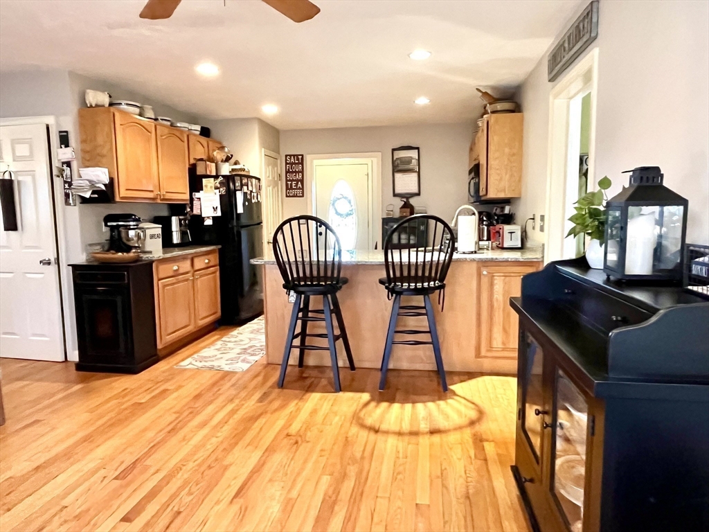 2 Pierce Circle Paxton, MA 01612 - Photo 8 of 31 a kitchen with stainless steel appliances granite countertop a stove top oven a sink a dining table and chairs with wooden floor