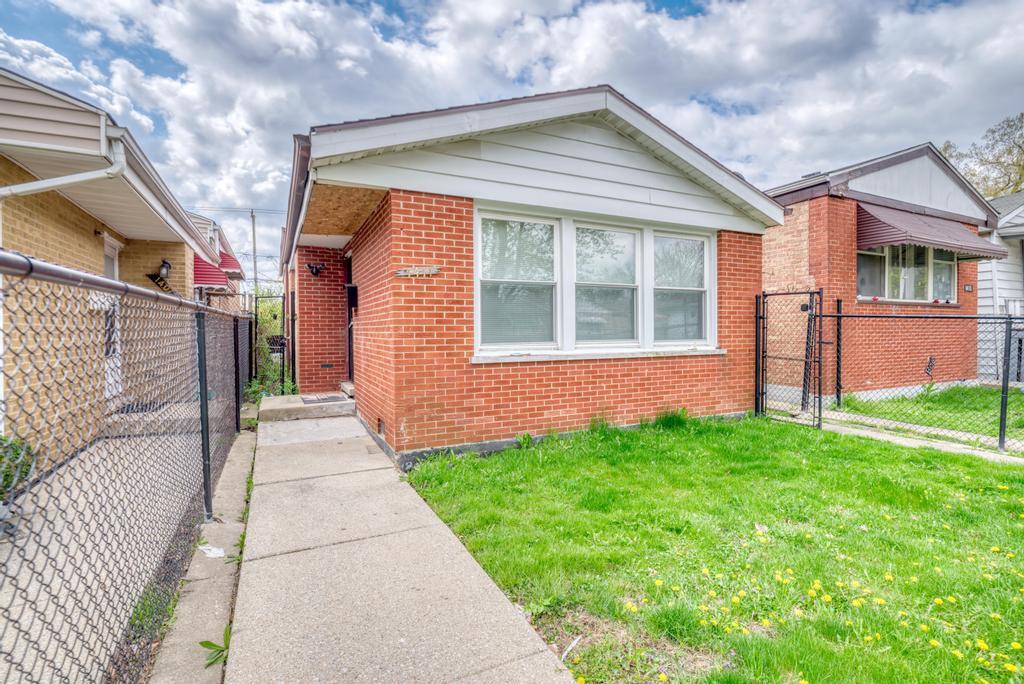 1411 West 114th Place Chicago, IL 60643 - Photo 1 of 25 a front view of a house with a yard