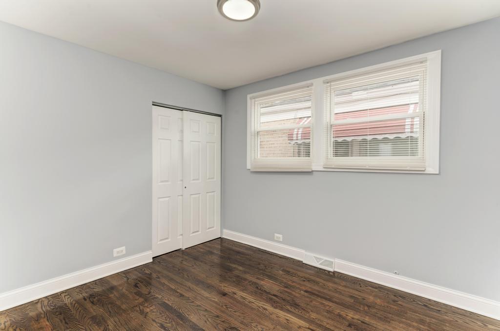 1411 West 114th Place Chicago, IL 60643 - Photo 12 of 25 an empty room with wooden floor and windows