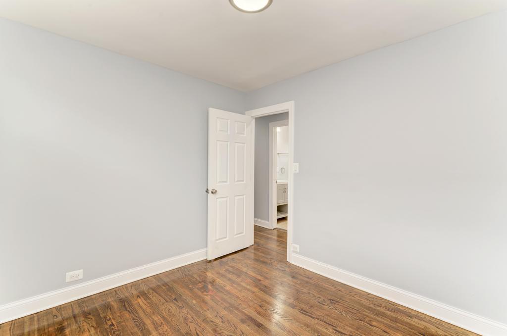 1411 West 114th Place Chicago, IL 60643 - Photo 13 of 25 a view of an empty room and wooden floor