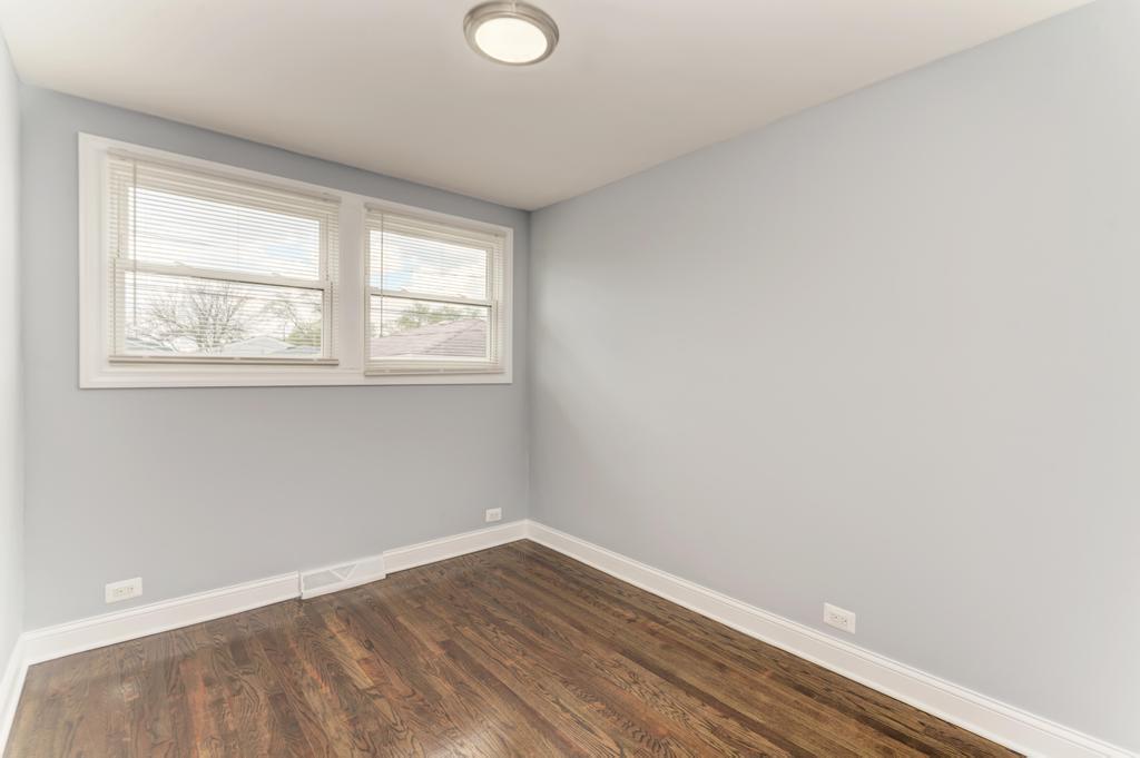 1411 West 114th Place Chicago, IL 60643 - Photo 14 of 25 an empty room with wooden floor and windows