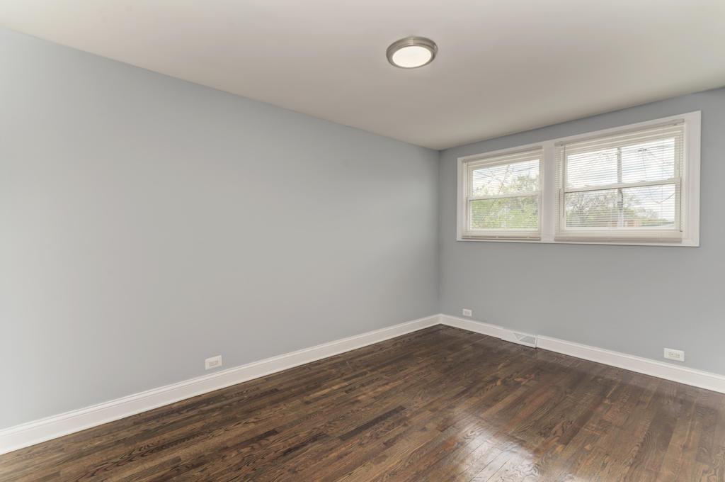 1411 West 114th Place Chicago, IL 60643 - Photo 16 of 25 an empty room with wooden floor and windows