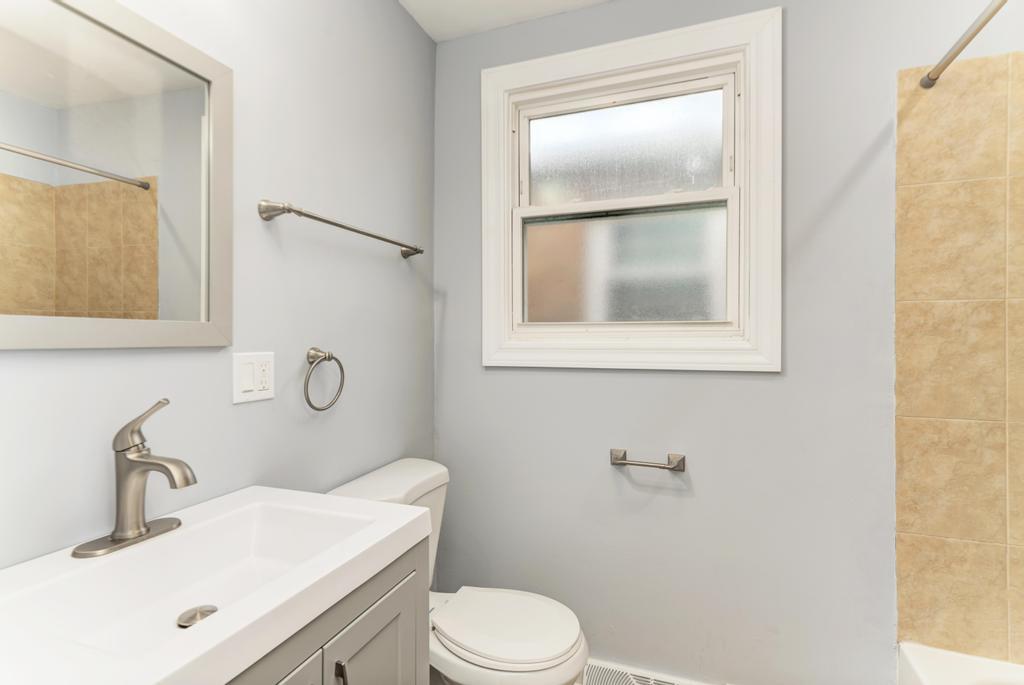 1411 West 114th Place Chicago, IL 60643 - Photo 18 of 25 a bathroom with a sink vanity mirror and toilet