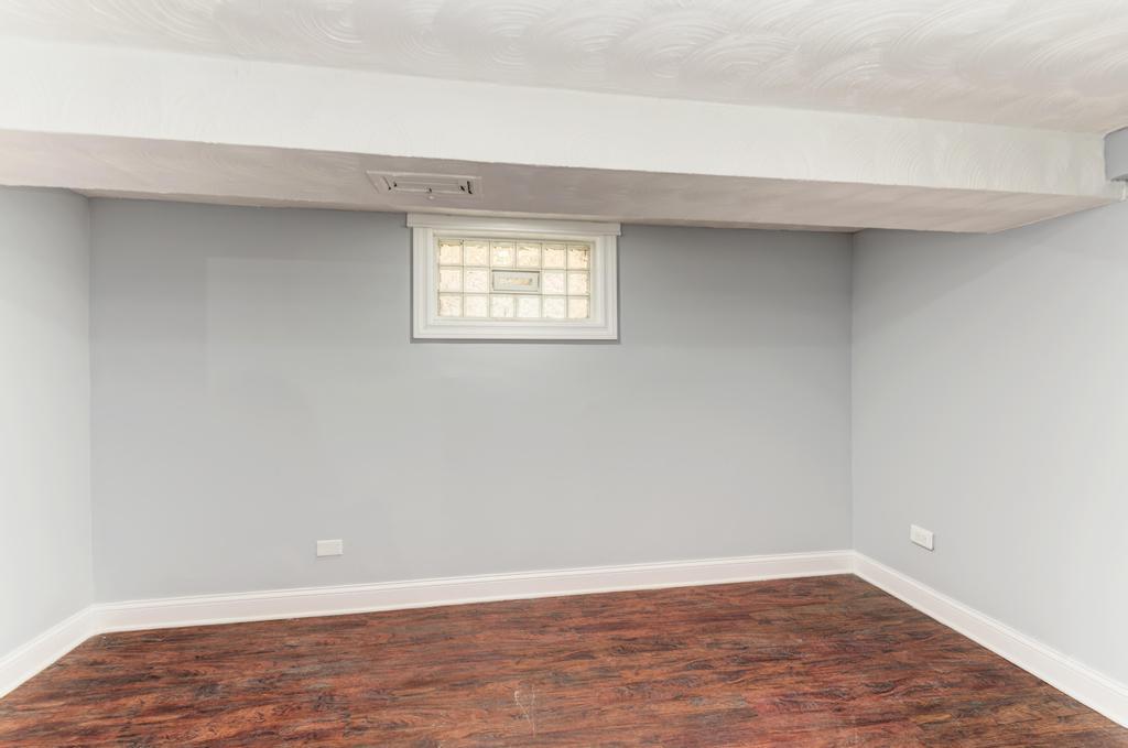1411 West 114th Place Chicago, IL 60643 - Photo 21 of 25 a view of an empty room with wooden floor and a window