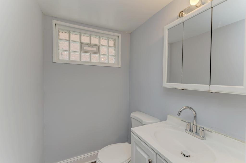 1411 West 114th Place Chicago, IL 60643 - Photo 22 of 25 a bathroom with a sink toilet and mirror