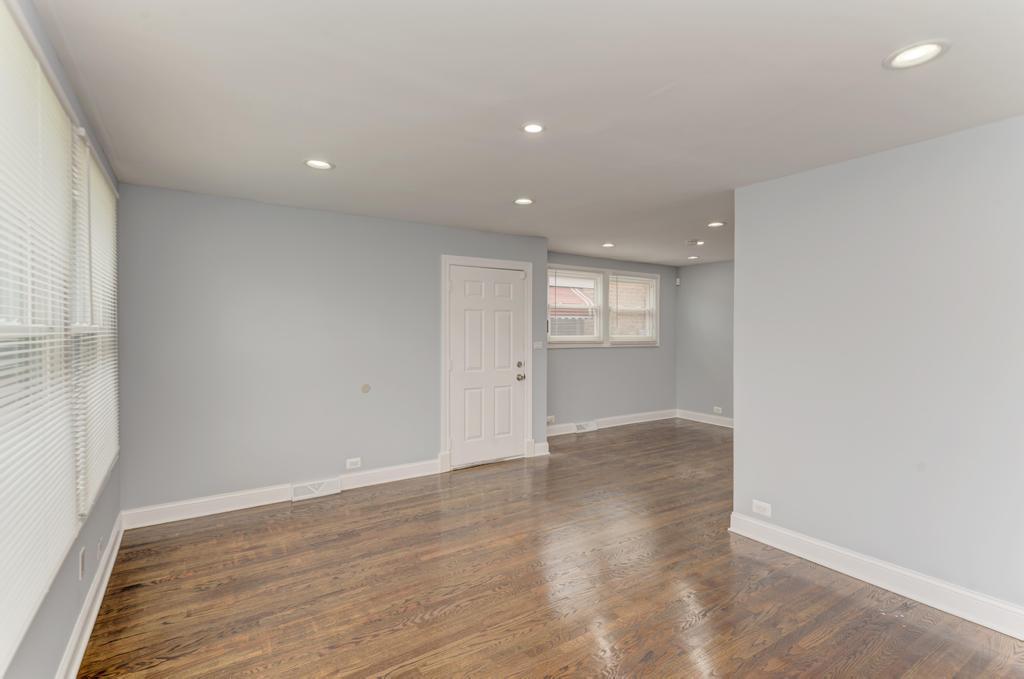 1411 West 114th Place Chicago, IL 60643 - Photo 5 of 25 an empty room with wooden floor and windows