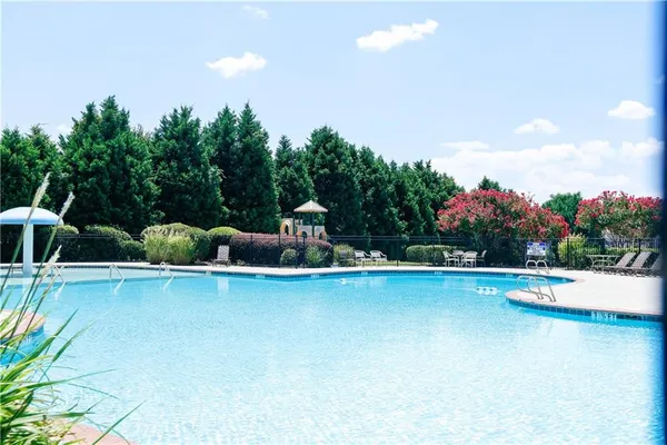 a view of a swimming pool and lounge chair