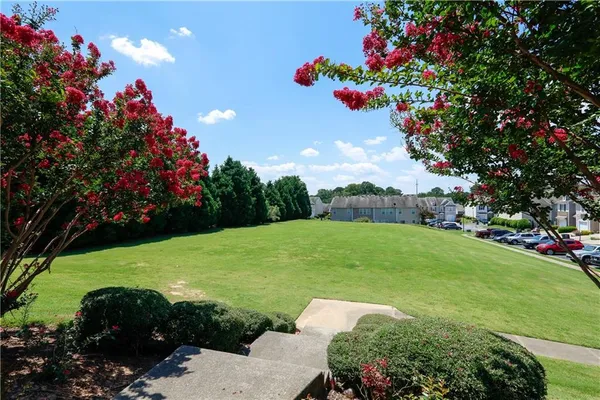 a view of a garden with a building in the background